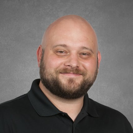 Portrait of James Todd in a black polo